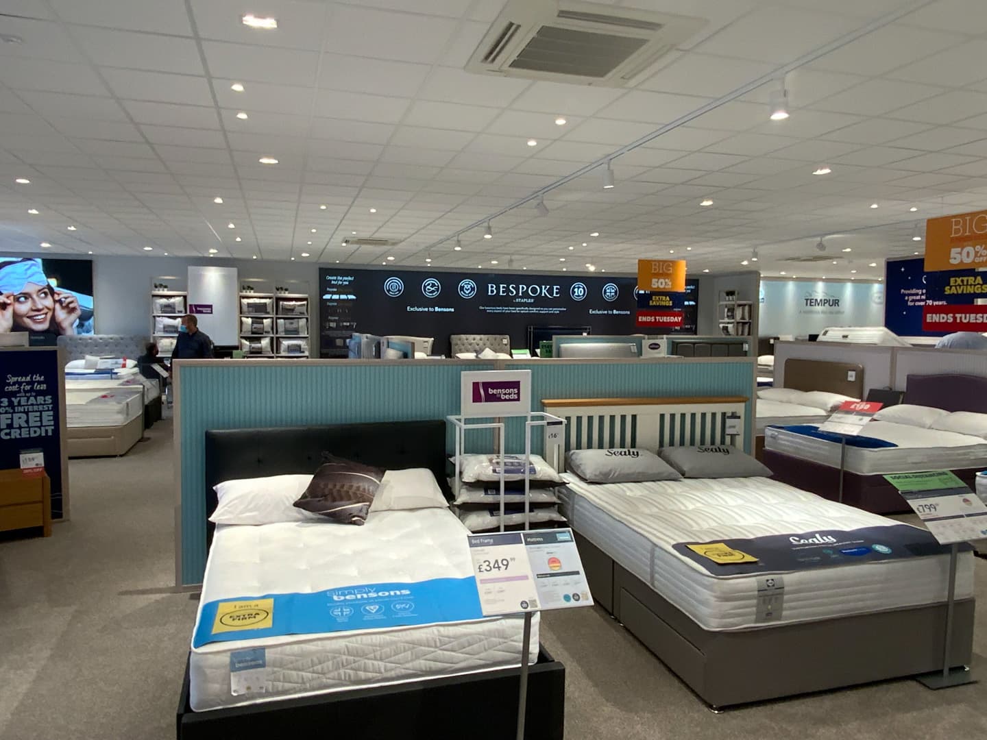 White grid and tile suspended ceiling in a Bensons for Beds showroom, Stockport