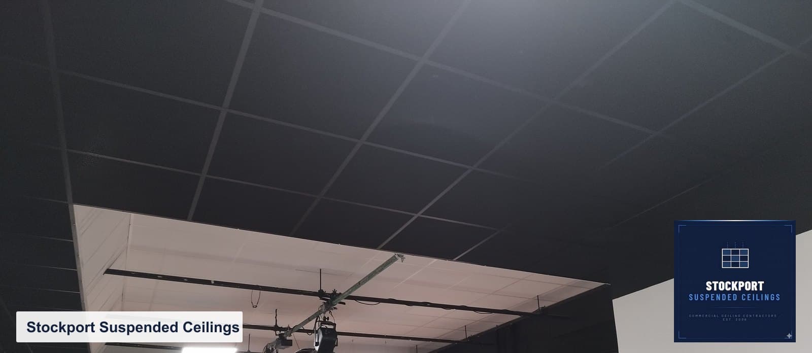 Black acoustic ceiling tiles set square in the grid in a Heaton Mersey studio