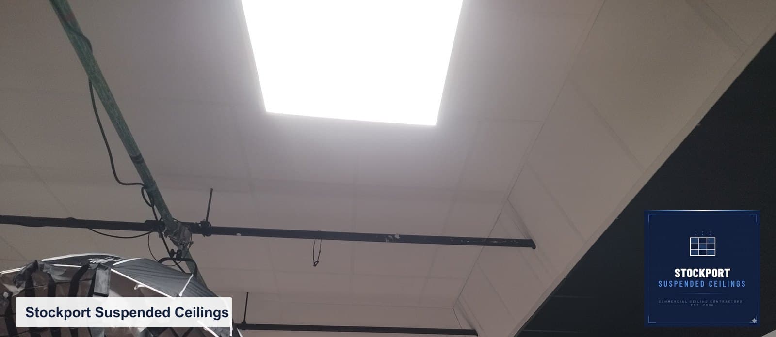 Black grid acoustic ceiling viewed across the studio ceiling line