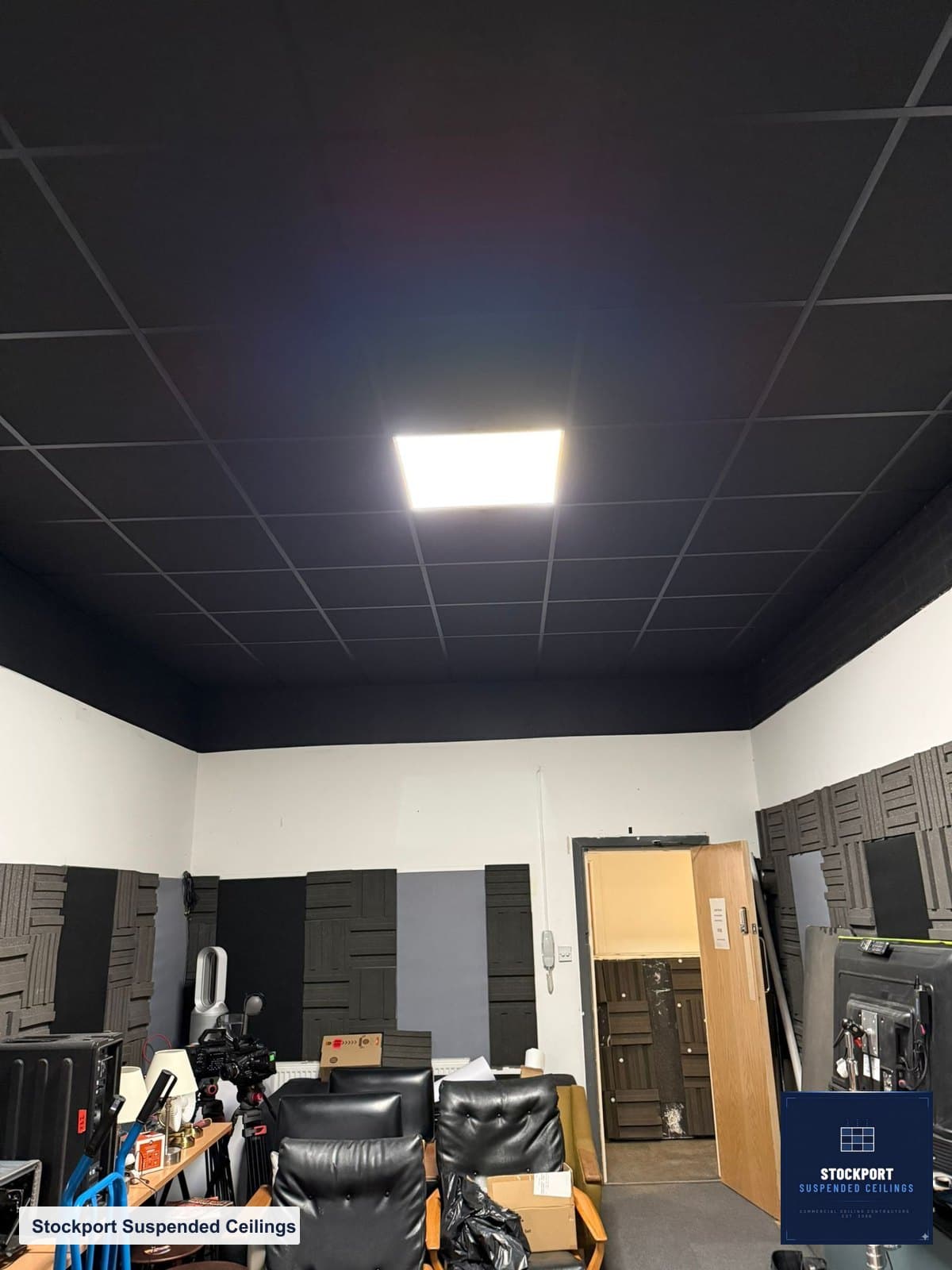 Finished black grid acoustic ceiling with recessed LED panel in a recording studio in Heaton Mersey, Stockport