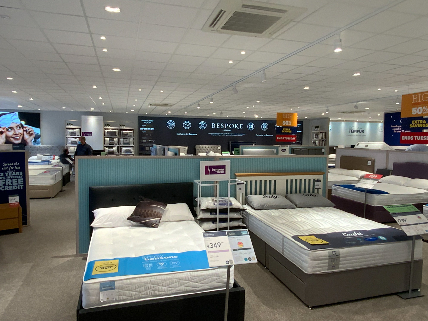 Grid and tile ceiling across a Bensons for Beds showroom, Stockport